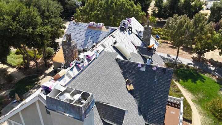 Charcoal shingles under the oaks by Precise Roofing