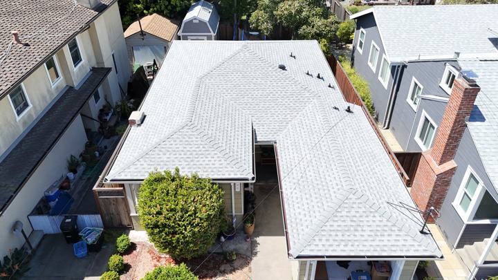 Light gray shingles on a hip roof by Precise Roofing