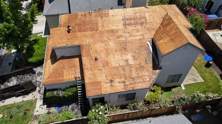 Hip roof deck under the trees by Precise Roofing