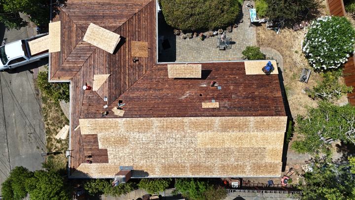 Old wood shake coming off by Precise Roofing